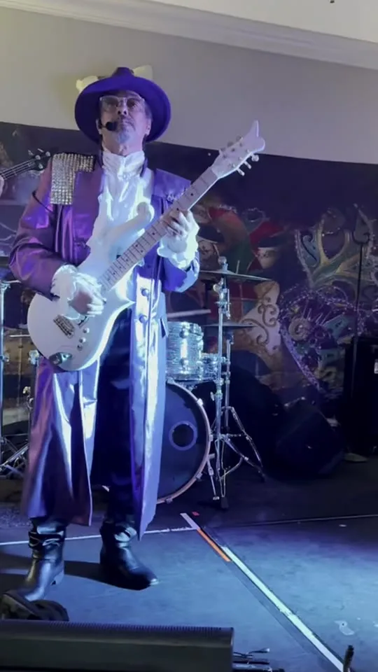 Shelton Sonnier performing live in purple stage attire
